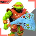 Figura de acción articulada de 14 cm del personaje MICHELANGELO MOTU x TMNT TURTLES OF GRAYSKULL MASTERS DEL UNIVERSO de MATTEL