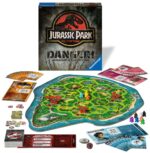 JURASSIC PARK DANGER JDM. Los primeros visitantes han llegado a Jurassic Park para conocer los impresionantes dinosaurios. Pero el caos se ha apoderado de la Isla Nublar: ¡No hay electricidad y las criaturas prehistóricas están a la caza! Un jugador controlará el T-Rex, el Dilophosaurus y el Velociraptor, que merodearán por la jungla hará atacar a los humanos. ¡Los otros jugadores serán os personajes de la clásica película y lucharán en equipo para hacer que la corriente vuelva a Jurassic Park y escapar de la isla antes de caer presos de los dinosaurios!. Se trata de un juego de estrategia donde los humanos  deberán salvarse y llegar al helipuerto antes de que los dinosaurios eliminen a tres personaje humanos. Cuando un Personaje Humano es eliminado por los Dinosaurios, ese Jugador Humano vuelve inmediatamente a jugar con un Personaje Humano completamente nuevo. Si éstos pueden llevar a un cierto número de Personajes humanos a un lugar seguro, los Humanos ganan. Pero si el Jugador Dinosaurio puede eliminar a 3 Personajes Humanos, los Dinosaurios ganan.