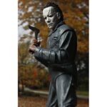 ULTIMATE MICHAEL MYERS HALLOWEEN: THE CURSE OF MICHAEL MYERS. Neca presenta la figura articulada Ultimate Michael Myers basada en la película "Halloween 6: The Curse of Michael Myers" ("Halloween 6: La maldición de Michael Myers" en España). Esta figura mide 18 cm e incluye 2x cabezas intercambiables, 1x máscara removible, 5x manos intercambiables, 1x hacha, 1x machete, 1x palanca, 2x cuchillos de cocina, 1x bolsa de runas, 4x velas de sacrificio, 1x conjunto de jeringas, 1x calabaza y 1x cartel de Strode Realty con la silueta de Michael Myers. Se presenta en una caja con ventana y tapa frontal abatible.