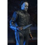 ULTIMATE MICHAEL MYERS HALLOWEEN: THE CURSE OF MICHAEL MYERS. Neca presenta la figura articulada Ultimate Michael Myers basada en la película "Halloween 6: The Curse of Michael Myers" ("Halloween 6: La maldición de Michael Myers" en España). Esta figura mide 18 cm e incluye 2x cabezas intercambiables, 1x máscara removible, 5x manos intercambiables, 1x hacha, 1x machete, 1x palanca, 2x cuchillos de cocina, 1x bolsa de runas, 4x velas de sacrificio, 1x conjunto de jeringas, 1x calabaza y 1x cartel de Strode Realty con la silueta de Michael Myers. Se presenta en una caja con ventana y tapa frontal abatible.