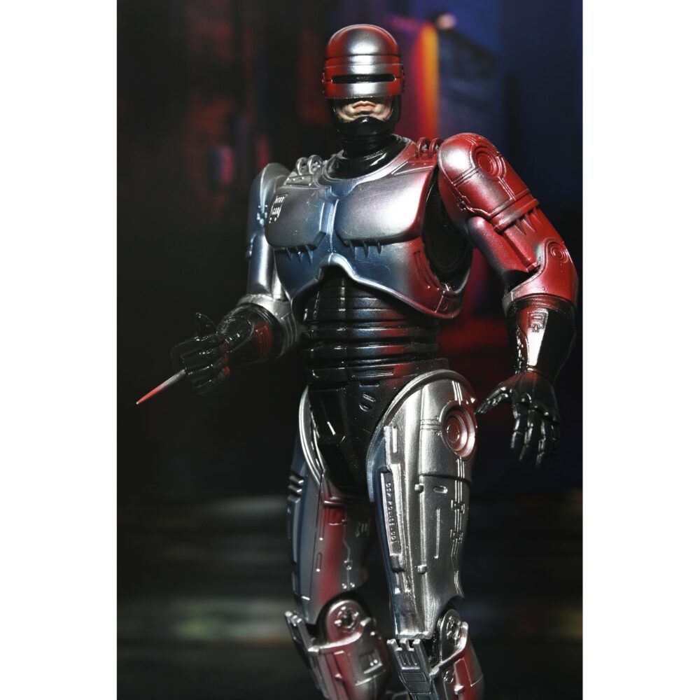 Ultimate robocop poster series. Neca introduce en su línea ultimate esta figura articulada de robocop, inspirada en el póster original de la película homónima de 1987.   mitad hombre. Mitad máquina. ¡pura policía! Neca se enorgullece de presentar la primera figura de acción de su nueva línea de figuras de acción poster series: una nueva figura de robocop basada en el clásico de culto. Esta figura articulada de 18 cm rinde homenaje al famoso póster de robocop de 1987, con una decoración especial que recrea el icónico arte del póster. Combate a criminales y droides renegados con una variedad de accesorios, como la pistola auto-9, la mano con pico de datos intercambiable, el cañón de asalto cobra y el efecto de disparo de pistola. Viene en una caja con ventana ideal para coleccionistas.