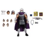 ULTIMATE SHREDDER (CLASSIC COLORS) TEENAGE MUTANT NINJA TURTLES CARTOON. Neca presenta la figura con colores clásicos de Ultimate Shredder, basada en la serie de televisión de los años 80 "Teenage Mutant Ninja Turtles". Esta figura mide 18 cm e incluye 2x cabezas intercambiables, 4x manos extras, 1x disquete, 1x arma, 1x collar, 1x paquete de billetes, 1x marco de foto y accesorios inspirados en episodios. Se presenta en una caja con ventana y tapa frontal abatible.