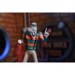 CREEPY EDDIE AND SHIBANO-SAMA TEENAGE MUTANT NINJA TURTLES CARTOON. Neca incorpora a su catálogo este set de figuras articuladas de Creepy Eddie y Shibano-Sama, basado en el cómic "Teenage Mutant Ninja Turtles: Saturday Morning Adventures". Ambas figuras tienen 18 cm de altura e incluyen 6x pares de manos intercambiables, 1x katana, 2x partes inferiores fantasmales, 1x par de tirantes removibles de Creepy Eddie, 1x casco Dream-O-Vision (compatible con la mayoría de las figuras de esta colección), y otros accesorios. El set incorpora una base de exposición con brazo articulado oficial de Neca. Presentado en una caja ilustrada con ventana.