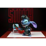 ULTIMATE SINGER ELVIS STITCH LILO & STITCH. ¿Estás listo para el rock? La colección Disney Stitch Inspired by Elvis es la forma perfecta de celebrar a Disney Stitch y mostrar tu amor por la legendaria estrella del rock Elvis Presley. Estas creaciones con licencia oficial que presentan a Disney Stitch vestido de Elvis seguro que añaden un poco de encanto rock 'n' roll y nostalgia a tu colección. Tu ohana de figuritas no estará completa sin esta figurita de Elvis Cantante Definitivo de NECA. Vestida con un traje de cuero negro como el que llevaba Elvis, esta figura articulada de Disney Stitch mide más de 5 cm y está lista para dar un espectáculo que nunca olvidarás. Los accesorios incluyen cabezas, manos, pelo y ojos intercambiables, además de una guitarra y una silla. Viene en un embalaje apto para coleccionistas.