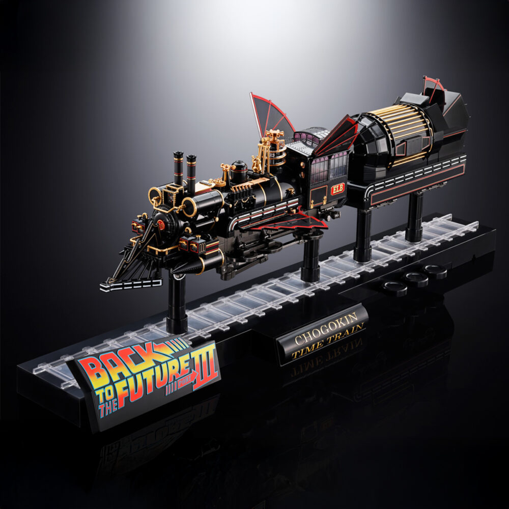Time train back to the future iii chogokin. Presenta dentro de la línea chogokin la máquina del tiempo con forma de locomotora de vapor que inventa el dr. Emmett brown en la película de 1990 "back to the future part iii" (o "regreso al futuro iii" en españa). Esta reproducción coleccionable que conmemora el 40º aniversario de la primera película está fabricada con abs, pvc y metal, y tiene una longitud de 48 cm. La base que recrea una vía de tren alcanza los 56 cm de largo y está decorada con el logotipo oficial de la película. Además, cuenta con un mecanismo que gira las ruedas y eleva el vehículo. Al añadir las alas incluidas como accesorio se completa el aspecto de la máquina del tiempo en modo vuelo. Los led bajo la locomotora y de la parte posterior se iluminan recreando el efecto de propulsión de la película. Algunas piezas se activan con electricidad como los engranajes de la locomotora que giran y cambian de dirección o la luz blanca del lateral que se enciende como en el filme. La puerta del conductor se abre hacia arriba, dejando al descubierto el interior de la cabina que se ha esculpido en base a documentación oficial. Se incluyen las figuras de los personajes que aparecen en la misma secuencia de la película y cuentan con una altura aproximada de 4 cm. La fuente de alimentación principal y el conector usb-c están situados en un extremo de la base, lo que elimina la necesidad de pilas para alimentar los diferentes mecanismos y las 56 luces led. Se incluye un cable usb type-a, pero no un adaptador usb. Unidades limitadas.