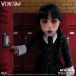 WEDNESDAY MDS ROTO PLUSH. Mezco suma a su línea MDS Roto Plush la figura de Wednesday Addams (conocida como Miércoles Addams en España), inspirada en la exitosa serie de Netflix "Wednesday". Tiene una altura aproximada de 45 cm. Se muestra con su característico gesto serio, un vestido negro manga larga con cuello alto, sus clásicas trenzas de cabello negro implantadas y zapatos al estilo Mary Jane. Cuenta con partes esculpidas sobre un cuerpo de felpa. Se presenta en una caja con ventana