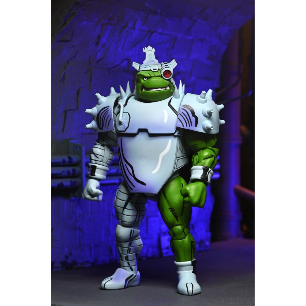CYBORG DONATELLO TEENAGE MUTANT NINJA TURTLES MIRAGE COMICS. Neca suma a su catálogo la figura de Cyborg Donatello, basada en la saga "Urban Legends" de los cómics de "Teenage Mutant Ninja Turtles" (“Las Tortugas Ninja” en España) de Mirage Studios por Eastman y Laird. Esta figura de articulada a escala de 18 cm de altura incorpora un esculpido totalmente nuevo e incluye 2x cabezas intercambiables, 1x sombrero de fiesta, 1x mano-cuchillo robótica, 4x manos adicionales y 1x bastón robótico. Se presenta en embalaje para coleccionistas con ilustraciones de Kevin Eastman con ventana y solapa frontal.