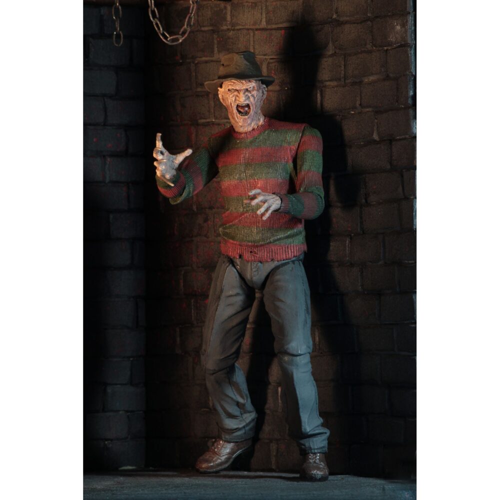 Ultimate freddy krueger a nightmore on elm street part 2. Neca vuelve a añadir a su línea ultimate la figura de freddy krueger basada en la película "a nightmare on elm street part 2: freddy's revenge" ("pesadilla en elm street 2: la venganza de freddy" en españa). Mide 18 cm e incluye 3x cabezas intercambiables, 2x perros demoníacos, 1x mano enguantada, 1x mano afilada, 1x sombrero extraíble y 1x efecto de fuego magnético. Se presenta en una caja con ventana y solapa frontal.