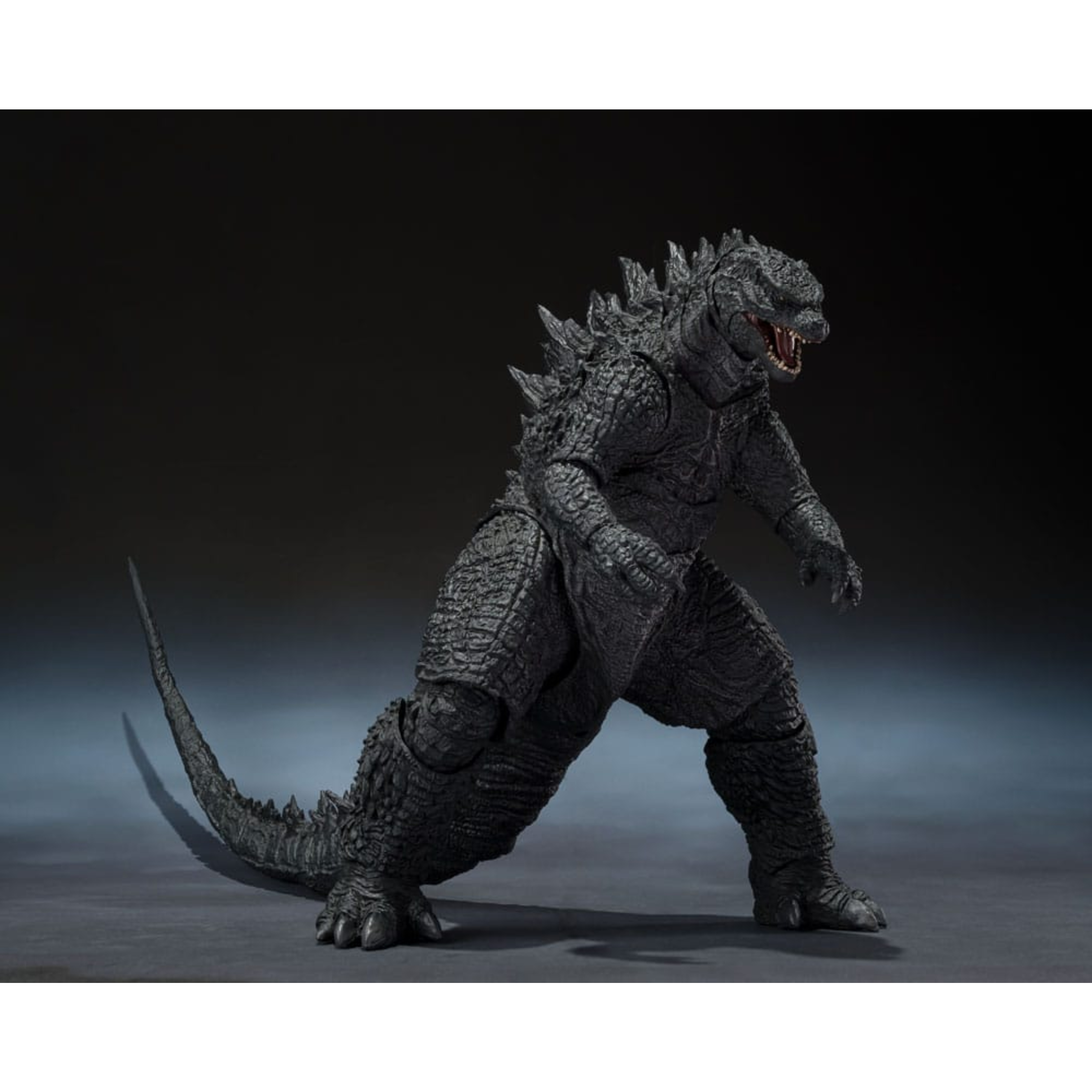 GODZILLA 2014 MOVIE GRAPHIC PLUS SH MONSTER ARTS Godzilla 2014 movie graphic plus sh monster arts. en 2014, godzilla renace en una versión moderna e imponente que relanza la leyenda del rey de los monstruos para toda una nueva generación. Esta edición movie graphic plus de tamashii nations rinde homenaje a este renacimiento cinematográfico combinando la figura con una imagen promocional inspirada en el cartel de la película. Con su diseño macizo, su complexión reptiliana realista y sus rugidos titánicos, el godzilla de 2014 simboliza el resurgimiento del kaijū en el panorama hollywoodiense. A la vez fuerza de la naturaleza y protector impredecible, encarna un fascinante equilibrio entre destrucción y majestuosidad. La figura adopta una postura reptante, con la cabeza gacha y la cola flexible extendida hacia atrás. El cuerpo está cubierto de escamas detalladas y oscuras, y las gruesas placas dorsales recuerdan la silueta icónica al tiempo que modernizan sus líneas. La base incluye un panel rígido con el cartel de la película, en el que godzilla domina una ciudad en llamas, lo que refuerza el impacto dramático de la pieza. Con sus 15 cm de altura, esta figura articulada ofrece una buena amplitud de movimientos gracias a las discretas articulaciones de los brazos, las piernas, la cabeza y la cola. Las texturas son precisas, la pintura realista y el conjunto captura a la perfección la esencia de esta versión más bestial del monstruo de culto.